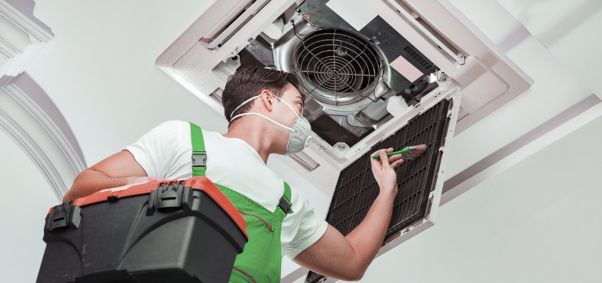 Technician providing air conditioner maintenance service